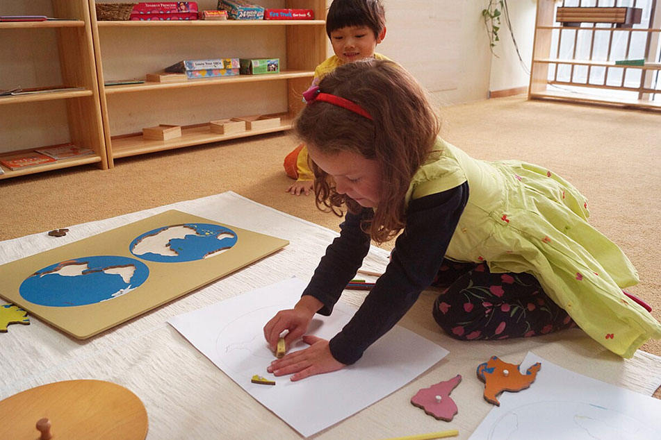 A girl drawing a map on the floor